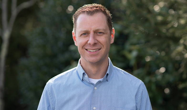 Dr. Schmitt smiles for. a photo outside.